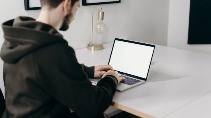 Man blogging on laptop with WordPress