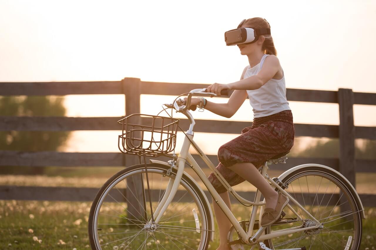 Girl on bicycle using AR headset